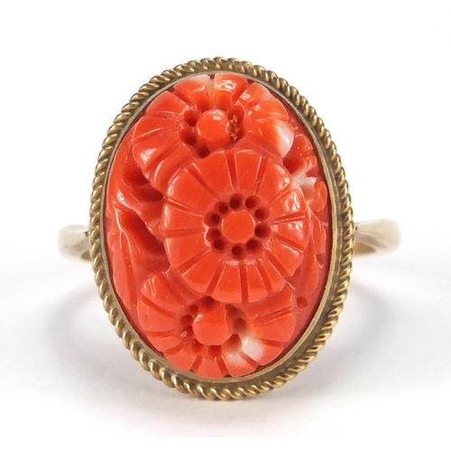 699 - 9ct gold coral ring carved with flower heads, size J, approximate weight 3.4g