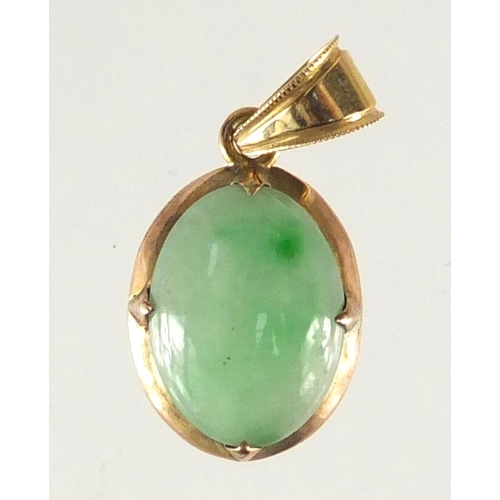 655 - Unmarked gold cabochon green jade pendant, matching earrings and one other, the pendant 2.1cm in len... 