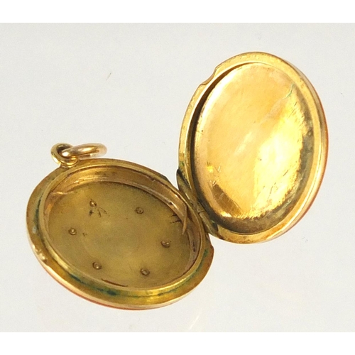 646 - Unmarked gold red guilloche enamelled locket with diamond snowflake decoration, 1.8cm in diameter, a... 