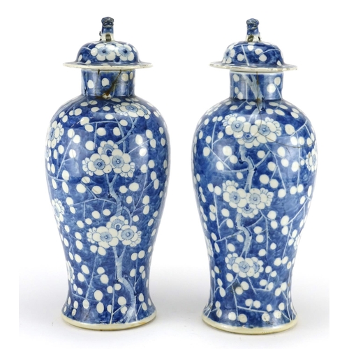 273 - Pair of Chinese blue and white porcelain baluster vases and covers, hand painted with Prunus flowers... 