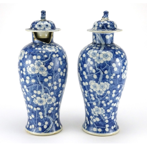 273 - Pair of Chinese blue and white porcelain baluster vases and covers, hand painted with Prunus flowers... 