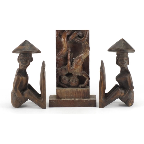 420 - Pair of African carved wood figural bookends and a carved wood panel of mermaids, 65cm in length