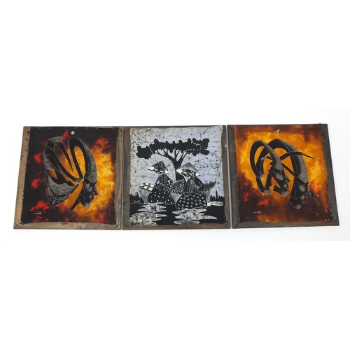 579 - Three abstract paintings on silk of surreal masks and figures, each framed, 46cm x 46cm