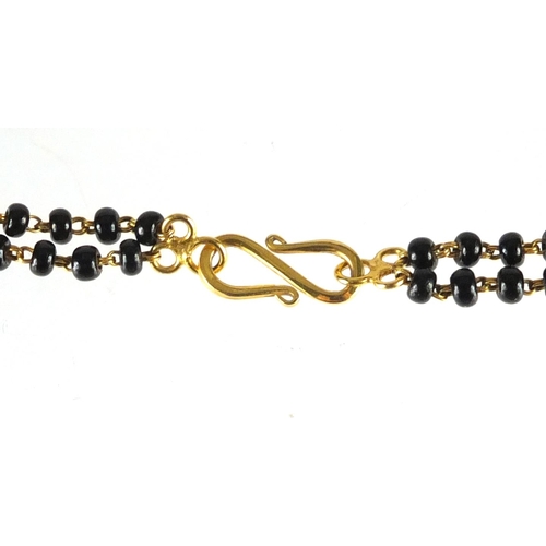 748 - Indian 22ct gold, diamond and black bead Mangalsutra marriage necklace, 62cm in length, approximate ... 