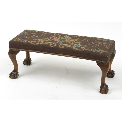 28 - Mahogany foot stool with ball and claw feet and needlepoint upholstery, 30cm H x 71cm W x 27cm D