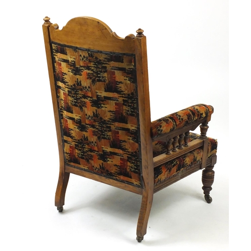 3 - Oak framed armchair with geometric upholstery, 111cm high