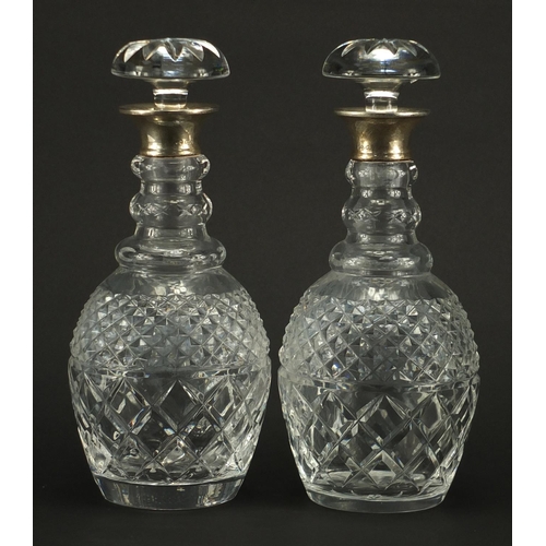 2147 - Pair of cut glass decanters with silver collars, indistinct London hallmarks, each 29.5cm high