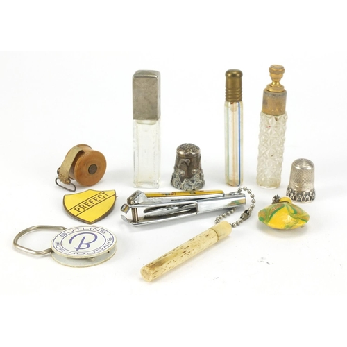 459 - Objects including glass scent bottles, bone needle case, treen sewing tape measure and silver thimbl... 