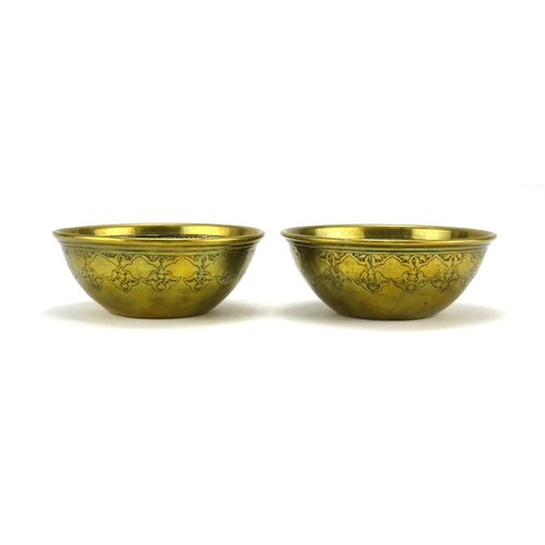 399 - Two Cairoware brass bowls, with copper and silver inlay decorated with script and star motifs, the l... 