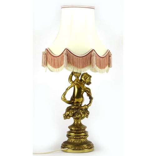2176 - Gilt brass putti design table lamp, with silk lined tasselled shade, 67cm high