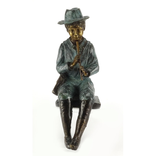 2119 - Bronze figure of a seated boy playing a flute, 32cm high