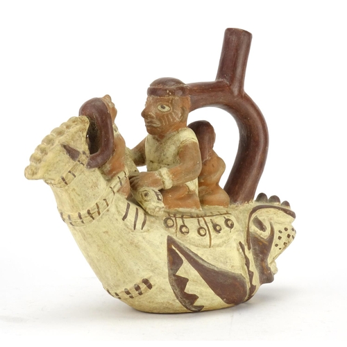 392 - Peruvian pottery Mochica style vessel modelled as three figures in a fish boat, 28cm in length
