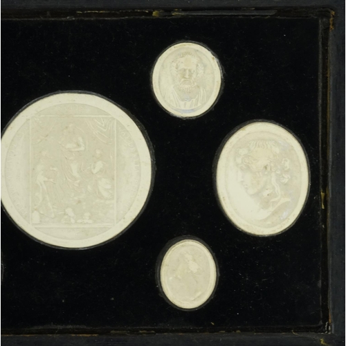 37 - Seven 19th century Grand Tour plaster plaques including six portraits, housed in a hanging display, ... 