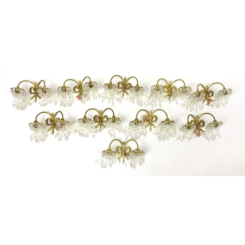 566 - Five pairs of brass bow design two branch wall lights, with glass drops
