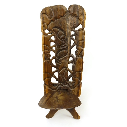 41 - African folding occasional chair carved with elephants, 120cm high