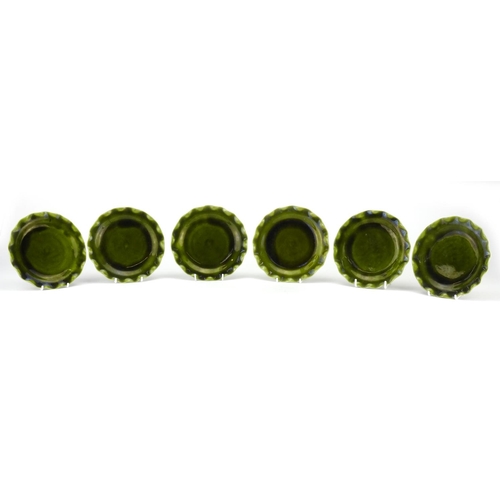 498 - Set of six Christopher Dresser design Linthorpe pottery green glazed plates with fluted rims, each w... 