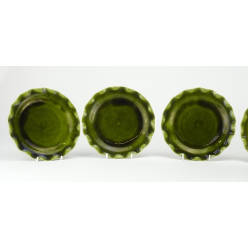 498 - Set of six Christopher Dresser design Linthorpe pottery green glazed plates with fluted rims, each w... 
