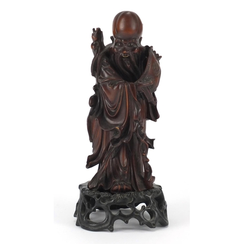 359 - Good Chinese root carving of an elder holding a scroll, raised on a carved hardwood stand, overall 2... 