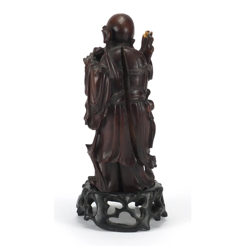 359 - Good Chinese root carving of an elder holding a scroll, raised on a carved hardwood stand, overall 2... 