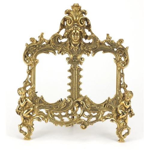 2152 - Ornate gilt brass strut double photo frame, cast in relief with acanthus leaves and putti, 34.5cm hi... 