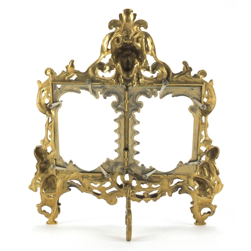 2144 - Ornate gilt brass strut double photo frame, cast in relief with acanthus leaves and putti, 34.5cm hi... 