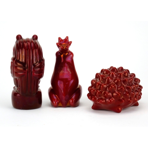 535 - Three Zsolnay Pecs red glazed animals including a hedgehog and owl, factory marks to the bases, the ... 