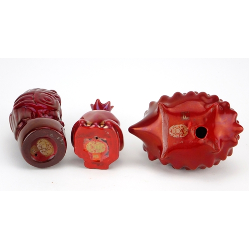 535 - Three Zsolnay Pecs red glazed animals including a hedgehog and owl, factory marks to the bases, the ... 