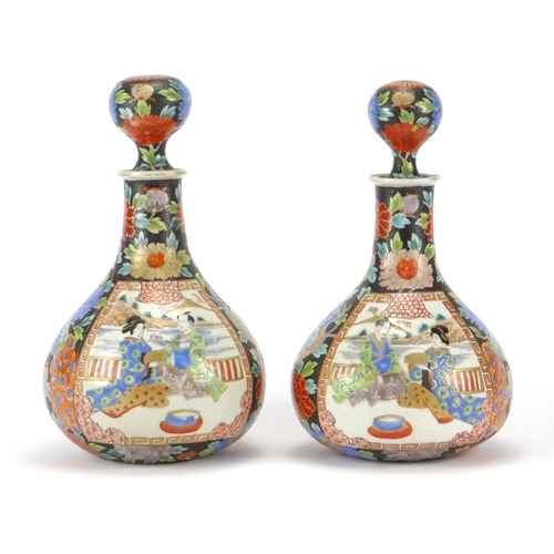 2181 - Pair of Japanese porcelain decanters,  hand painted with figures and flowers, each 24.5cm high