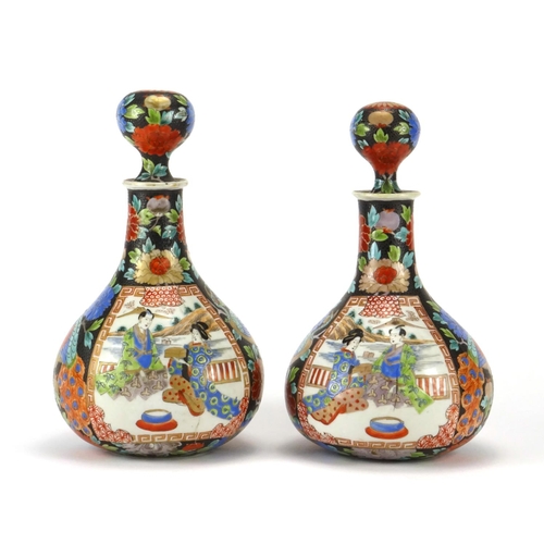 2181 - Pair of Japanese porcelain decanters,  hand painted with figures and flowers, each 24.5cm high