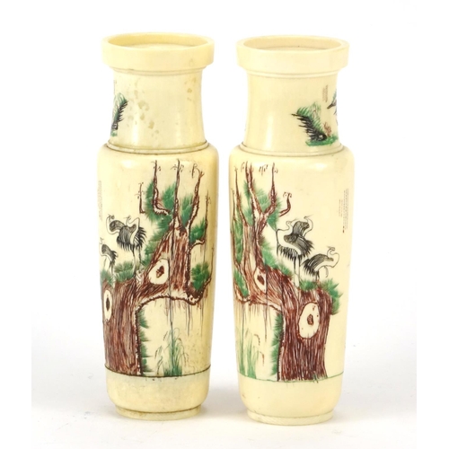 352 - Pair of Chinese turned ivory vases engraved with cranes amongst pine trees and calligraphy, each 14.... 