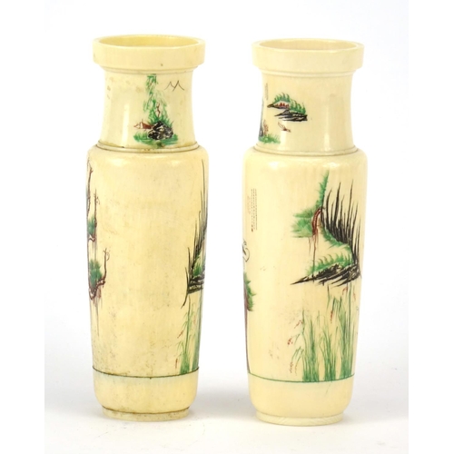 352 - Pair of Chinese turned ivory vases engraved with cranes amongst pine trees and calligraphy, each 14.... 