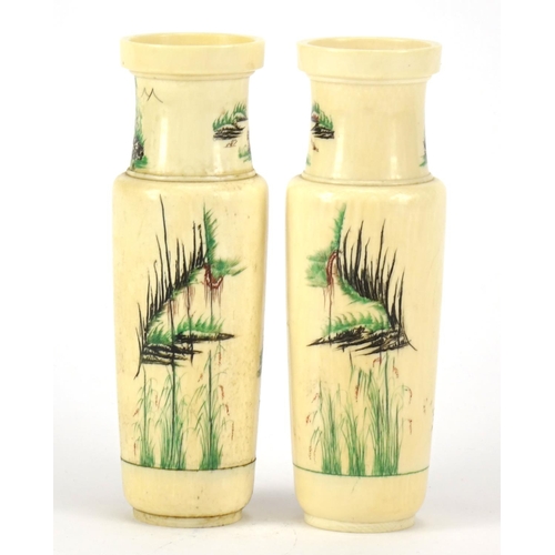 352 - Pair of Chinese turned ivory vases engraved with cranes amongst pine trees and calligraphy, each 14.... 