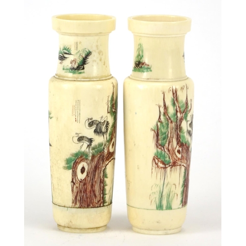 352 - Pair of Chinese turned ivory vases engraved with cranes amongst pine trees and calligraphy, each 14.... 