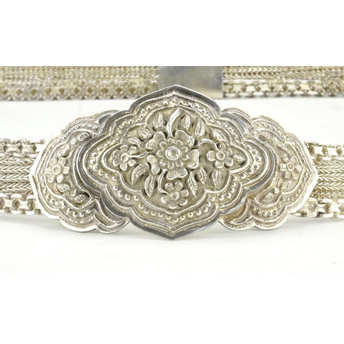 421 - Indian unmarked silver wedding belt, the buckle finely embossed with flowers, 86cm in length, approx... 