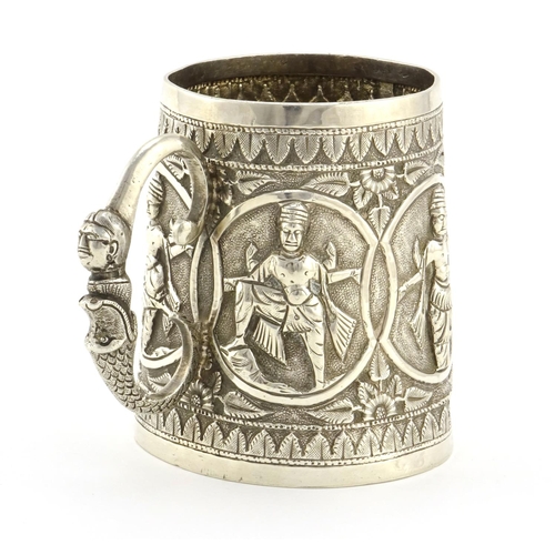 589 - Indian unmarked silver tankard, the tapering body embossed with five figures, 8.5cm high, approximat... 