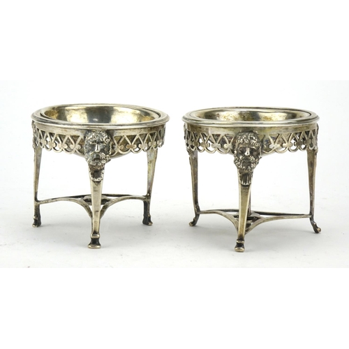 586 - Pair of antique silver three footed open salts with mask  decoration, indistinct impressed marks to ... 
