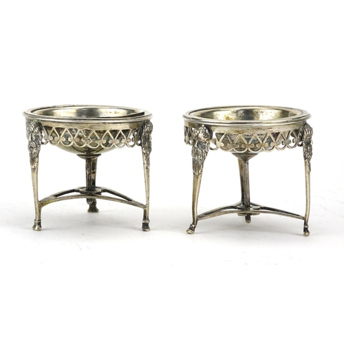 586 - Pair of antique silver three footed open salts with mask  decoration, indistinct impressed marks to ... 