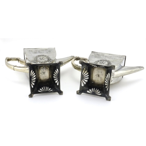 556 - Two Art Nouveau pewter coffee pots by WMF, decorated with ribbons, each with impressed marks and num... 