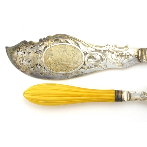 632 - Pair of Victorian fish servers, with ivory handles and silver plated blades engraved with a coastal ... 