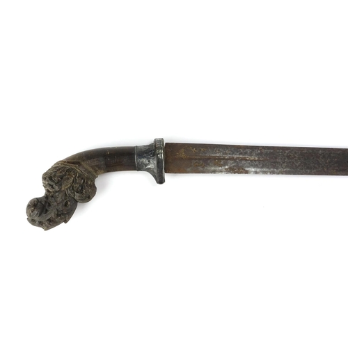 375 - Rhinoceros horn handled African sword with silver mount and wooden scabbard, the horn handle finely ... 