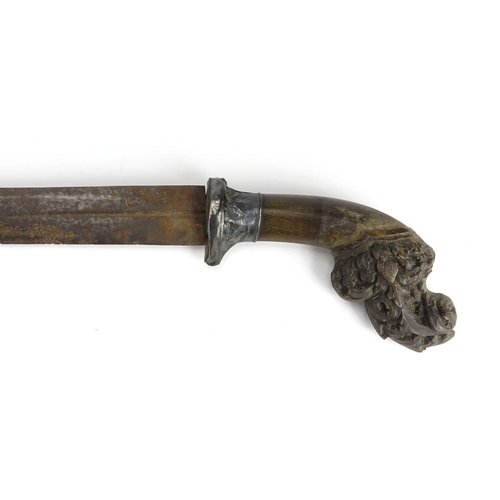 375 - Rhinoceros horn handled African sword with silver mount and wooden scabbard, the horn handle finely ... 