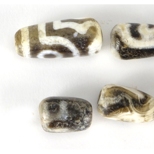 387 - Six Islamic agate beads, the largest 2.4cm wide