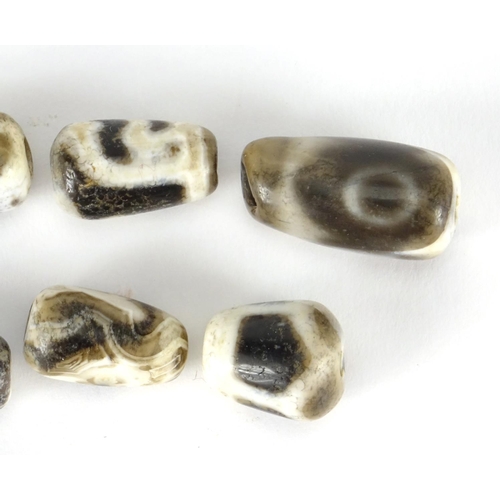 387 - Six Islamic agate beads, the largest 2.4cm wide
