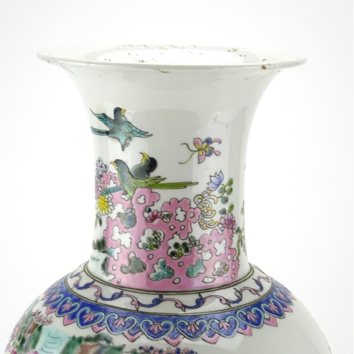 297 - Chinese porcelain baluster vase raised on a hardwood stand, finely hand painted in the famille rose ... 