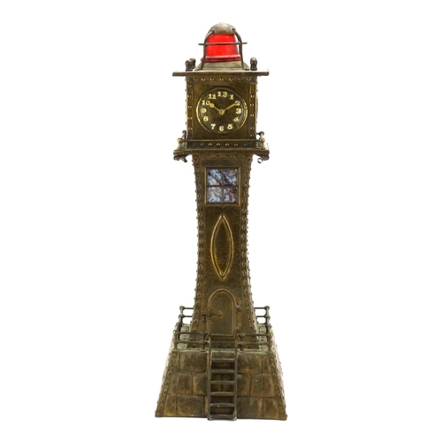 567A - Unusual Arts & Crafts style brass clock in the form of a lighthouse, with Arabic numerals, 53cm high