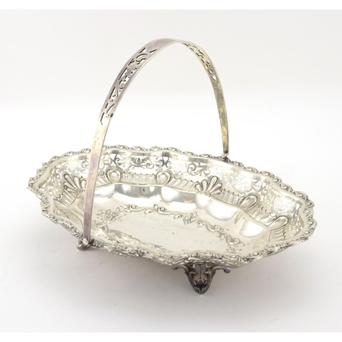 582 - Oval silver basket with embossed and pierced decoration and swing handle, by William Aitken Birmingh... 