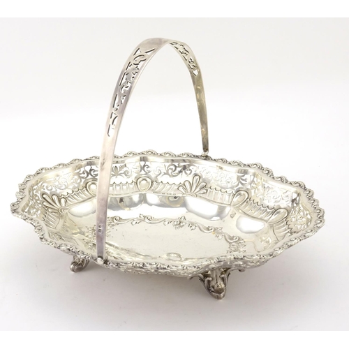 582 - Oval silver basket with embossed and pierced decoration and swing handle, by William Aitken Birmingh... 