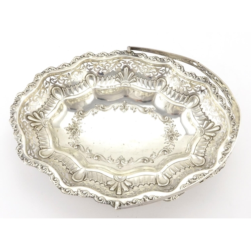 582 - Oval silver basket with embossed and pierced decoration and swing handle, by William Aitken Birmingh... 