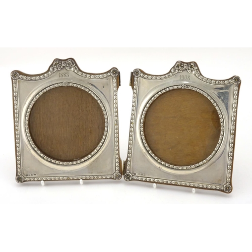 588 - Silver folding double photo frame, embossed with bows and rosettes, by Charles S Green & Co Ltd, Bir... 