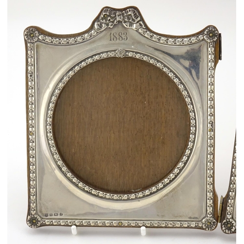 588 - Silver folding double photo frame, embossed with bows and rosettes, by Charles S Green & Co Ltd, Bir... 